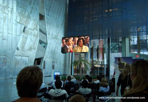 On January 21, 2009, in Federation Square in Melbourne, Australia, people gather to watch a re-broadcast of Barack Obama's take the oath of office to become the President of the United States.