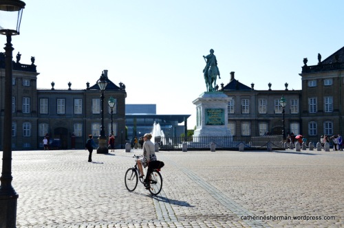 A biker crosses the courtyard of Amalienborg Palace, the winter residence of the Danish royal family. The equestrian statue is of Amalienborg's founder, King Frederick V.